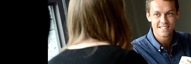 Gentleman in blue shirt in conversation with lady