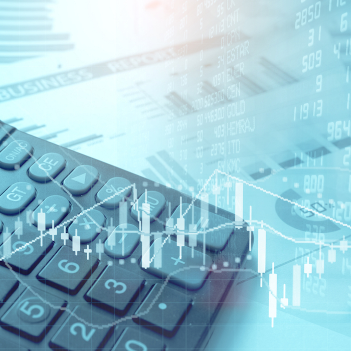 Calculator placed on a business report with financial figures and graphs overlay