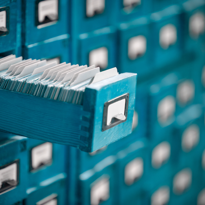 Close up of a traditional record card filing cabinet with drawer open