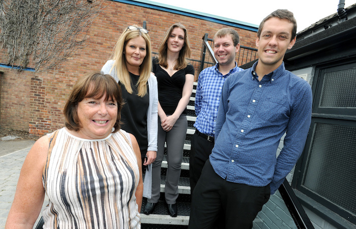 5 people stood outside on a staircase