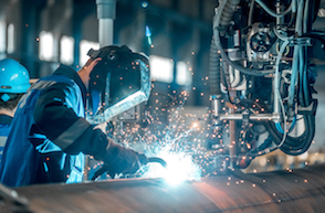 1 person wearing PPE working in a manufacturing environment