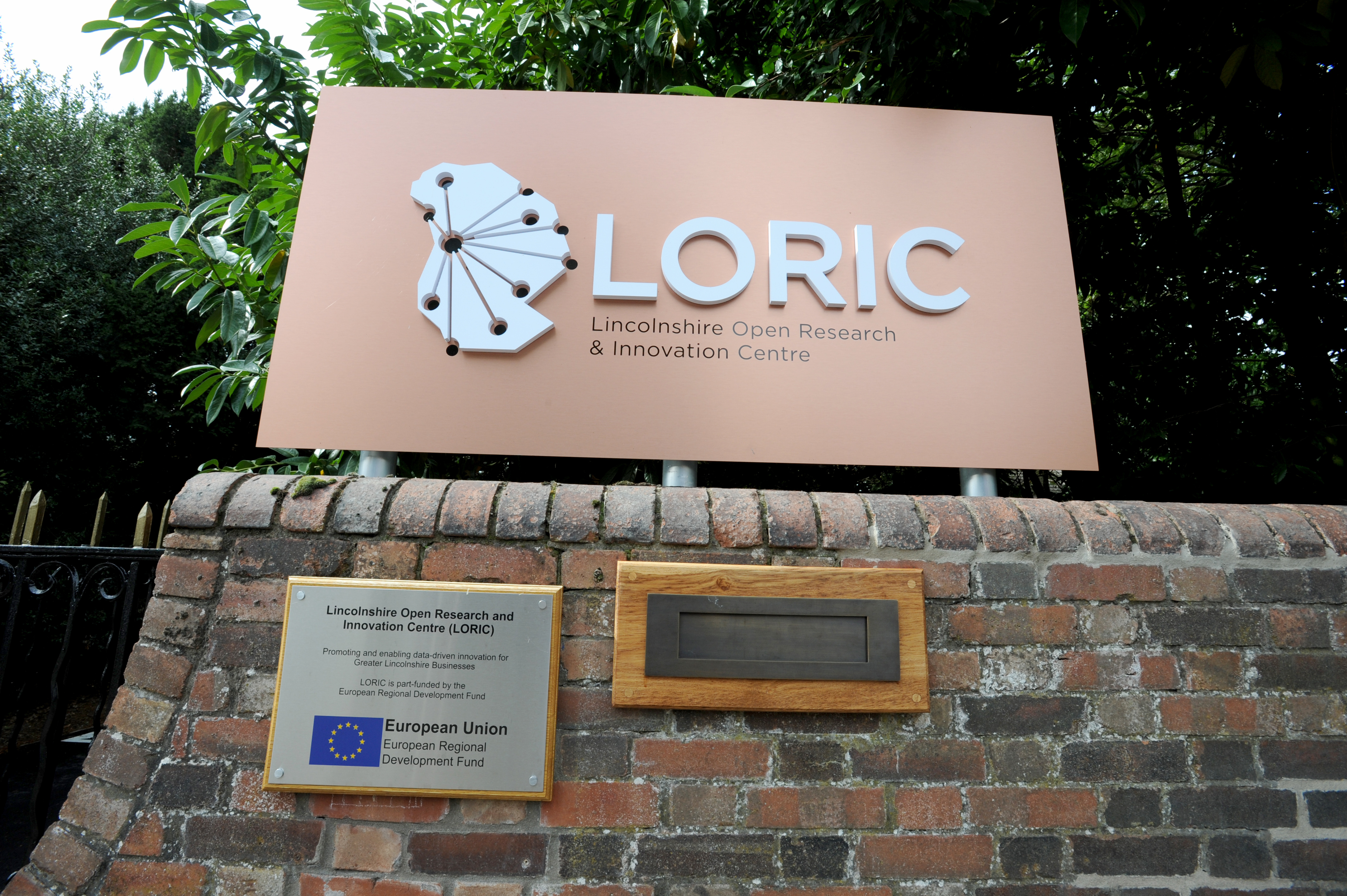 LORIC sign placed on top of brick wall