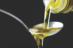 Oil being poured onto a spoon