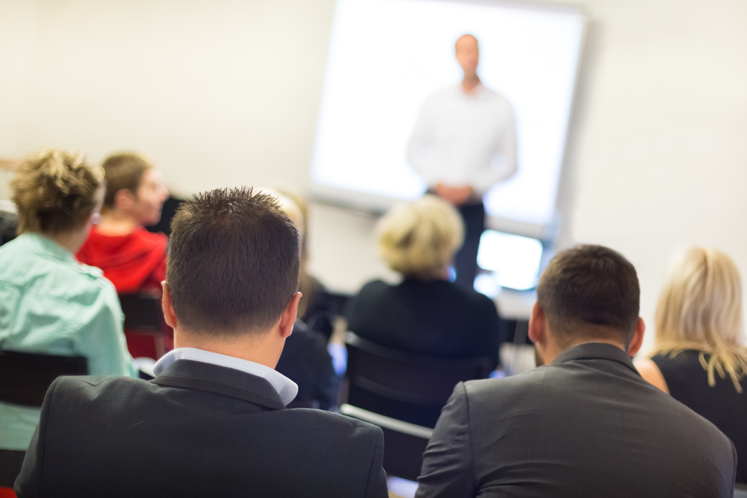 Image of people watching a public speaker