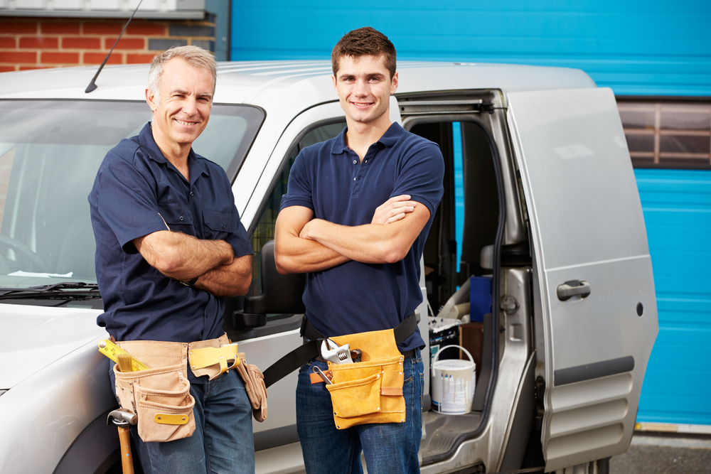 Two men stood in front of a van