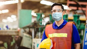 1 person wearing PPE working in a manufacturing environment