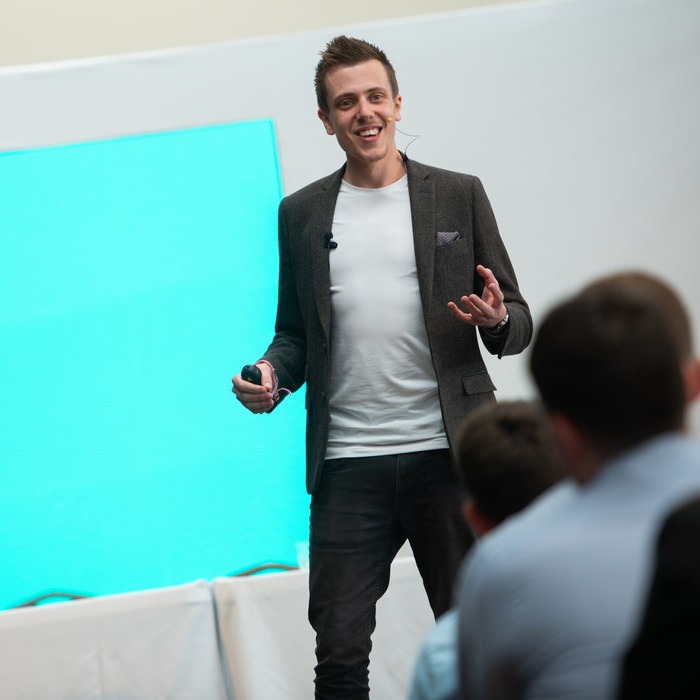 Gentleman speaking in front of group of people