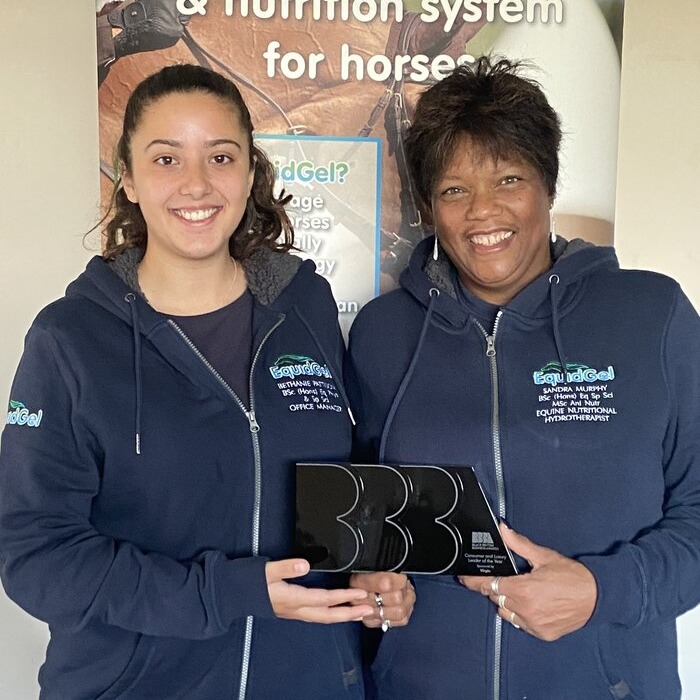 Two ladies collecting award