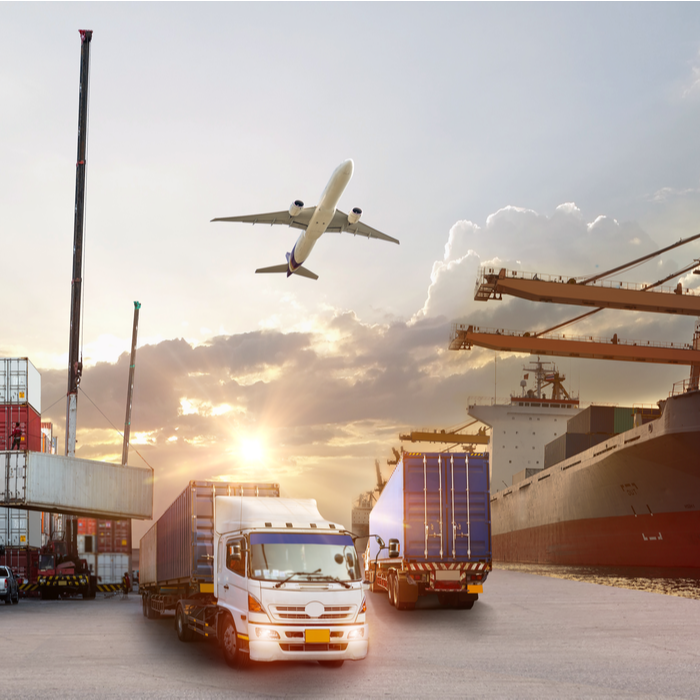 Picture of shipping containers, lorries, a plane and a ferry at a port.