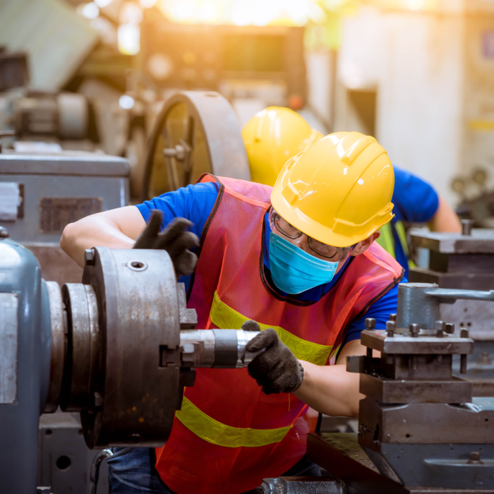 Man in protective equipment while handling machinery