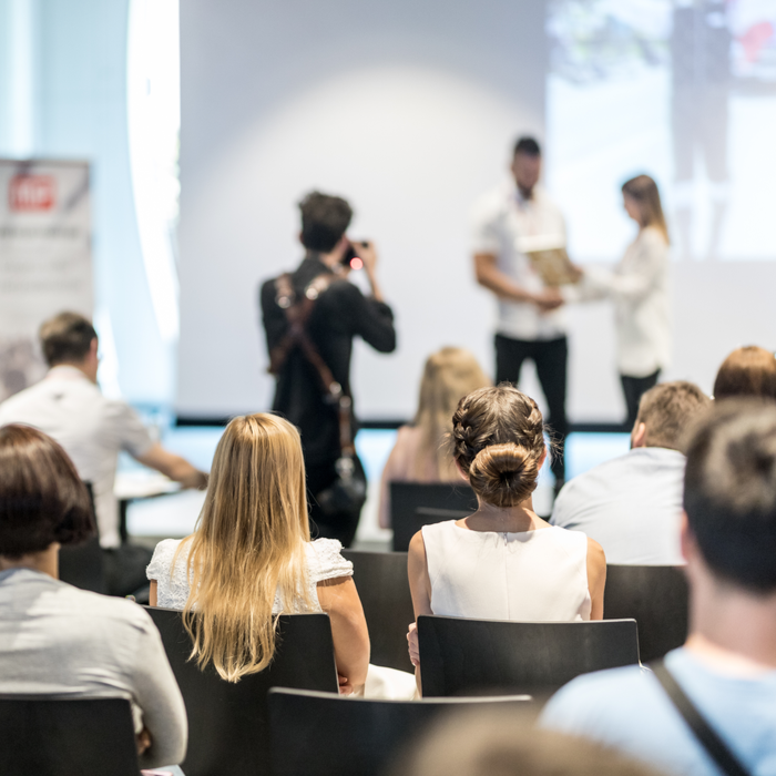 Someone winning an award in front of crowd