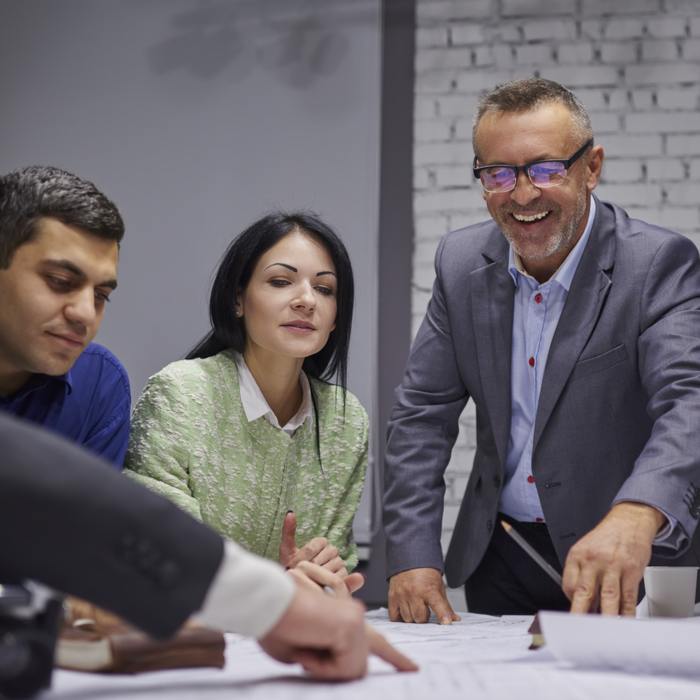 Next Level Scale Up Programme - people around a desk looking at plans - Business Lincolnshire