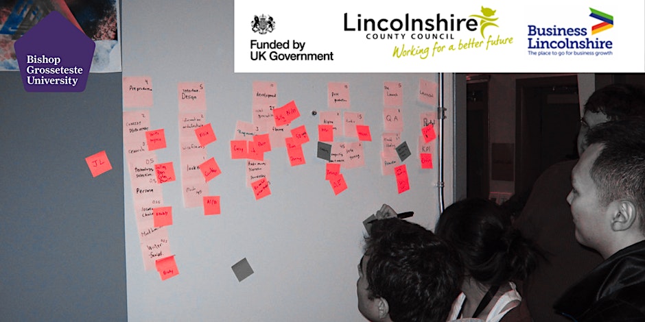 People viewing post-it notes on a white board