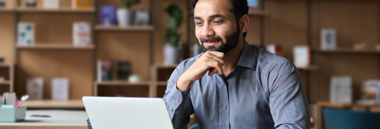 Man sat at his laptop smiling